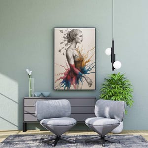 Pode incluir: Uma obra de arte emoldurada retrata o perfil de uma mulher com um design de respingos colorido. A obra de arte é exibida acima de um armário cinza com duas cadeiras giratórias cinza na frente. Uma moderna luminária preta com duas luzes de globo brancas pende do teto.