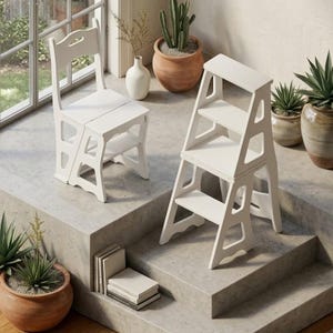 May include: Two white wooden step stools, one a chair-style and the other a three-step ladder. The chair has a curved back and a seat that folds down to reveal a step. The ladder has three steps. The stools are on a concrete surface.