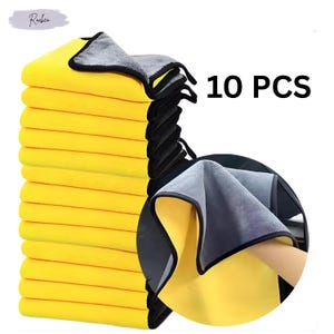 May include: A set of ten yellow microfiber cleaning cloths with grey borders and black edges. The cloths are folded and stacked, with some unfolded to show the grey side. The text "10 PCS" is displayed in bold black font.