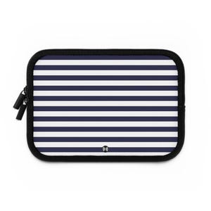 May include: A rectangular navy blue and white striped laptop sleeve with a black zipper and black trim. The sleeve has a wireless charging symbol on the bottom right corner.