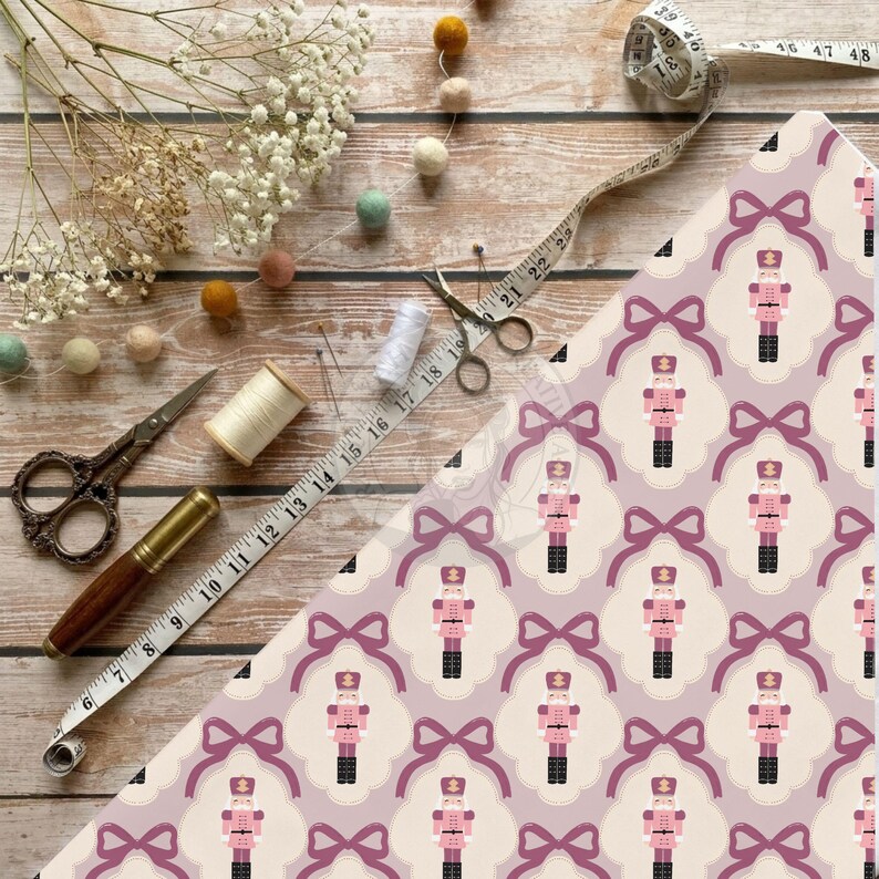 Pink nutcracker ribbon bow fabric print mockup on wooden board with sewing scissors and tape measure.