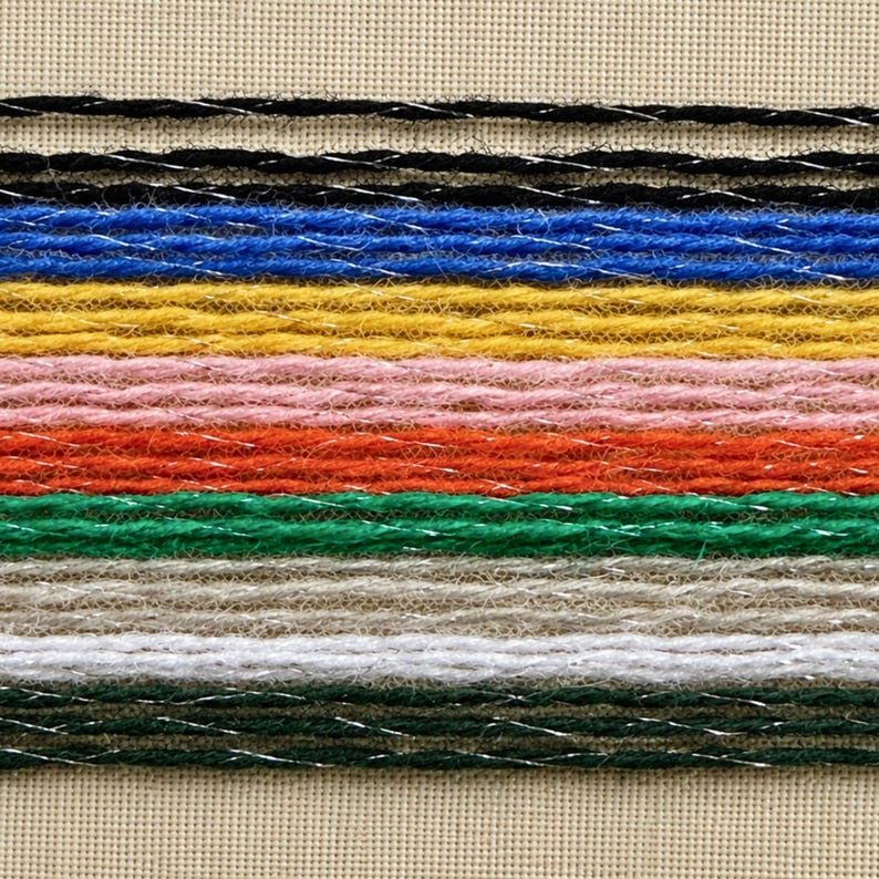 May include: A series of horizontal yarn strands arranged in parallel rows, featuring a variety of colors including black, blue, yellow, pink, orange, green, beige, white, and dark green, each intertwined with a thin, reflective silver metallic thread.