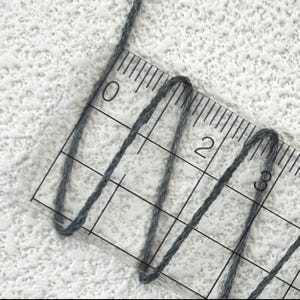 May include: A set of three ceramic mugs with a speckled, matte finish. The mugs are in shades of cream, light gray, and dark gray. Each mug has a simple, minimalist design, perfect for coffee or tea.