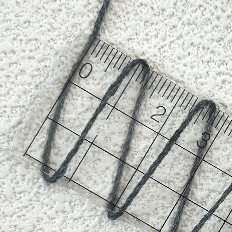 May include: A set of three ceramic mugs with a speckled, matte finish. The mugs are in shades of cream, light gray, and dark gray. Each mug has a simple, minimalist design, perfect for coffee or tea.