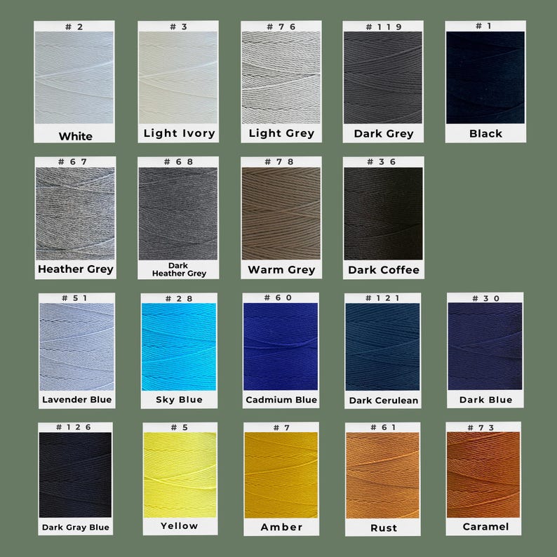 May include: A color chart featuring various shades of thread. The colors include white, light ivory, light grey, dark grey, black, heather grey, dark heather grey, warm grey, dark coffee, lavender blue, sky blue, cadmium blue, dark cerulean, dark blue, dark gray blue, yellow, amber, rust, and caramel.