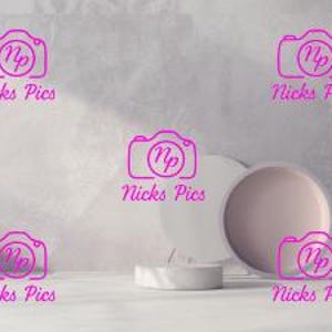 May include: A minimalist still life arrangement featuring ceramic plates, cylinders, and a decorative floral display. The color palette is soft, with muted tones of white, beige, and gray, creating a serene and modern aesthetic.