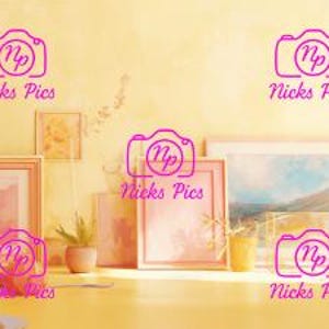 May include: A collection of framed artwork and decorative items arranged on a yellow wall. The frames vary in size and style, with some containing artwork and others appearing empty. A large potted plant and other decorative items are also present.