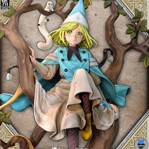May include: A detailed figurine of a character with blonde hair, wearing a blue and white outfit, and a pointed hat. The figure is posed sitting on a tree branch, with a small white creature nearby. The background is a stylized tree and foliage.