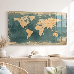 May include: A rectangular wall art piece featuring a world map with gold-coloured continents set against a distressed, textured teal blue background. The design displays a weathered, vintage-inspired aesthetic with visible paint-like brush strokes.