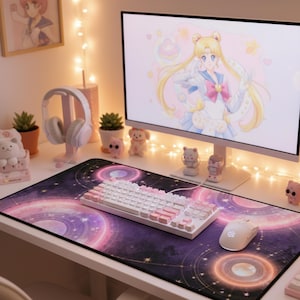 May include: A computer desk setup featuring a large mousepad with a purple and pink galaxy design, a white keyboard with pink accents, and a white mouse. A computer monitor displays anime art.