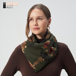 May include: A green and brown patterned neck warmer with gold-colored button closures. The neck warmer features a geometric design in shades of brown, red, and black. The word "TREND" and "AIN" are printed on the top left corner.