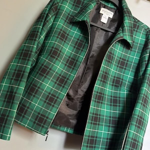 May include: A set of three ceramic mugs with a speckled, matte finish in cream, light grey, and dark grey. Each mug has a simple, minimalist design and a rounded handle.