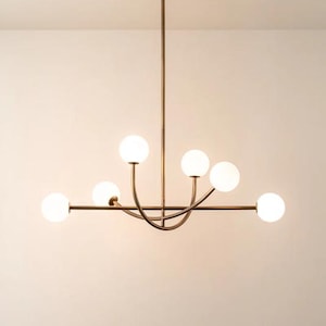 Pu&ograve; includere: Un lampadario moderno con finitura bronzo. L'apparecchio ha sei globi sferici in vetro smerigliato. L'apparecchio &egrave; sospeso al soffitto da un'unica asta.