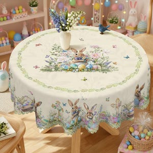 May include: A round Easter tablecloth with a cream background. The design features bunnies, Easter eggs, flowers, and butterflies. A green border with leaves surrounds the edge. The tablecloth is set on a wooden table.