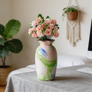 May include: A set of three ceramic mugs with a speckled, matte finish. The mugs are in shades of cream, light gray, and dark gray. Each mug has a simple, minimalist design, perfect for coffee or tea.