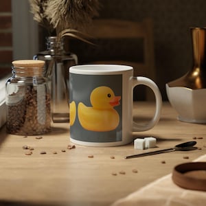 May include: A white ceramic mug with a black handle and the text "But First, Coffee" in a handwritten style. The mug is likely 325 ml and suitable for hot beverages.