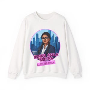 May include: White sweatshirt featuring a graphic of a woman with glasses, braids, and a business suit, set against a cityscape. The design includes the text "RENDU JALLA SEETHA CEO Edition" in a pink and purple color scheme.