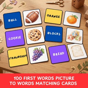 May include: A set of square educational matching cards featuring illustrations of a football, orange, cookie, alphabet blocks, grapes, and bread, paired with cards displaying the words BALL, ORANGE, COOKIE, BLOCKS, STRAWBERRY, and BREAD in black text.