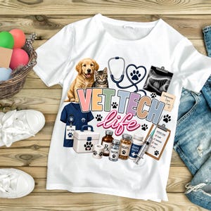 May include: A white t-shirt featuring a graphic print with a golden retriever puppy, a tabby kitten, a stethoscope, an x-ray, a blue scrub top, a medical kit, medicine bottles, and a syringe. The text reads VET TECH life and Compassion Care.