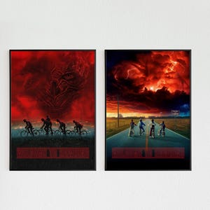 May include: Two framed art prints. One shows a red sky with a monster and cyclists. The other depicts cyclists on a road under a fiery sky. Both prints display the text "WELCOME TO HAWKINS" in a red font.