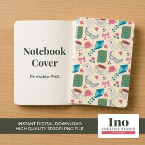 May include: An open notebook with a cream cover, the left page blank, the right with a pattern of teacups, books, bows, and masks. Text reads "Notebook Cover" and "Printable PNG." The notebook is on a wooden surface.