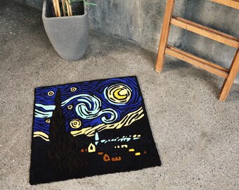 May include: A square rug featuring a vibrant depiction of Van Gogh's "Starry Night" painting. The rug showcases a dark blue sky with swirling yellow and light blue brushstrokes, a yellow moon, and a dark silhouette of a town.