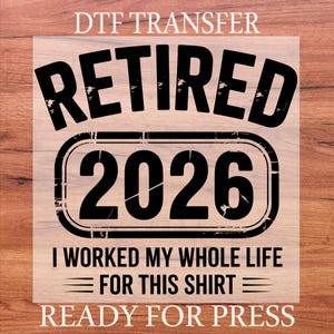 May include: Black DTF transfer with the words "RETIRED 2026" in a bold font. Below the year is the text "I WORKED MY WHOLE LIFE FOR THIS SHIRT". The words "DTF TRANSFER" and "READY FOR PRESS" are also included.