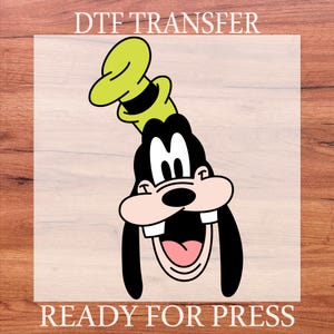 May include: A DTF transfer featuring a cartoon image of Goofy with a green hat and black ears. The character is smiling with a pink tongue and white teeth. The text "DTF TRANSFER" and "READY FOR PRESS" are at the top and bottom.