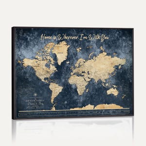 May include: A rectangular wall map featuring a dark navy blue textured background with gold-colored continents. The text "Home is Wherever I'm With You" appears at the top, and "THE ADVENTURES OF Danna & Troy" is printed in the lower left corner.