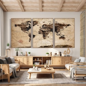 May include: Three framed vintage-style world maps in shades of brown and beige. The maps are displayed above a wooden cabinet in a living room setting. The room features light-colored furniture and decor.