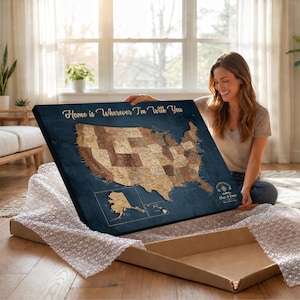 May include: A rectangular wall art canvas featuring a map of the United States in shades of brown against a dark blue background. The text Home is Wherever I'm With You is printed in gold at the top, with Chris & Emma below a compass icon.