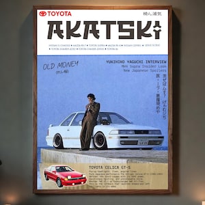 Puede incluir: Un póster enmarcado con un diseño de portada de revista que muestra el logotipo de Toyota y el título "AKATSKI". La imagen presenta un coche blanco y un hombre con traje. El texto incluye "OLD MONEY" y "YUKIHIKO YAGUCHI INTERVIEW".