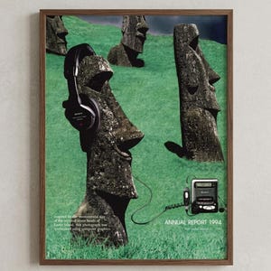 May include: A framed poster featuring stone Moai statues on a green grassy hill. One statue wears black Sony headphones connected by a wire to a portable Sony cassette player. Text reads: Inspired by the mystical stone heads of Easter Island, this photograph was synthesized using computer graphics. ANNUAL REPORT 1994.