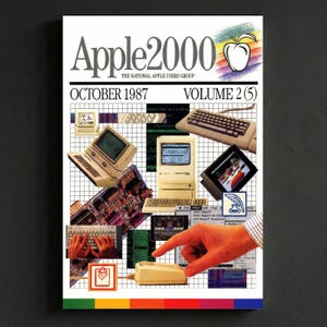 May include: A vintage magazine cover titled "Apple2000" from October 1987, featuring a collage of early computer technology. The design includes images of computers, keyboards, and a mouse, with a colorful apple logo.