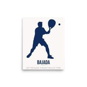 May include: A white poster featuring a dark blue silhouette of a person playing padel with a racket and ball. The text BAJADA is printed in dark blue, with the phrase OFF THE GLASS, STRAIGHT BACK AT THEM in smaller grey letters below it.