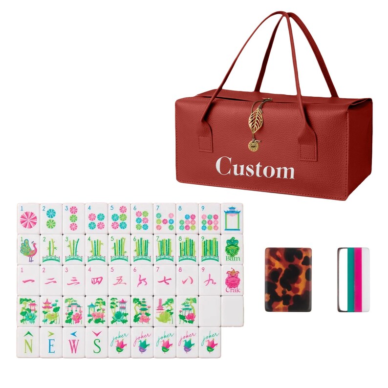May include: A red rectangular carrying case with the word Custom printed in white, featuring a gold leaf charm. Beside it are white mahjong tiles with colorful floral, bamboo, and character designs, along with two additional tiles with tortoise shell and striped patterns.