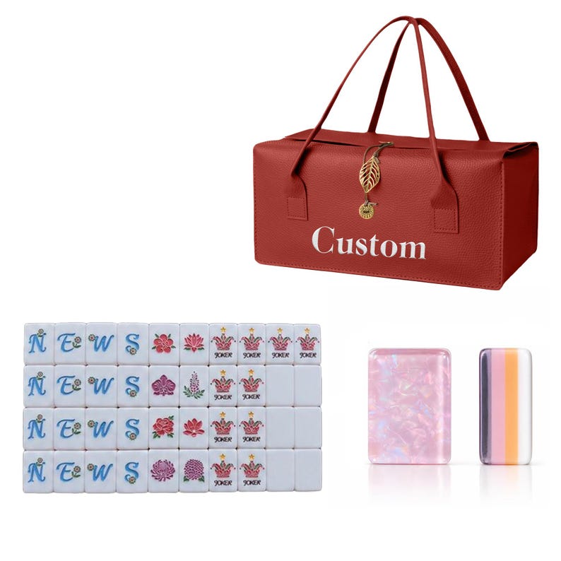 May include: A red rectangular carrying bag with the word Custom printed in white, featuring a gold leaf-shaped charm. Below are white mahjong tiles with blue letters, floral designs, and Joker icons, plus two translucent rectangular tiles.
