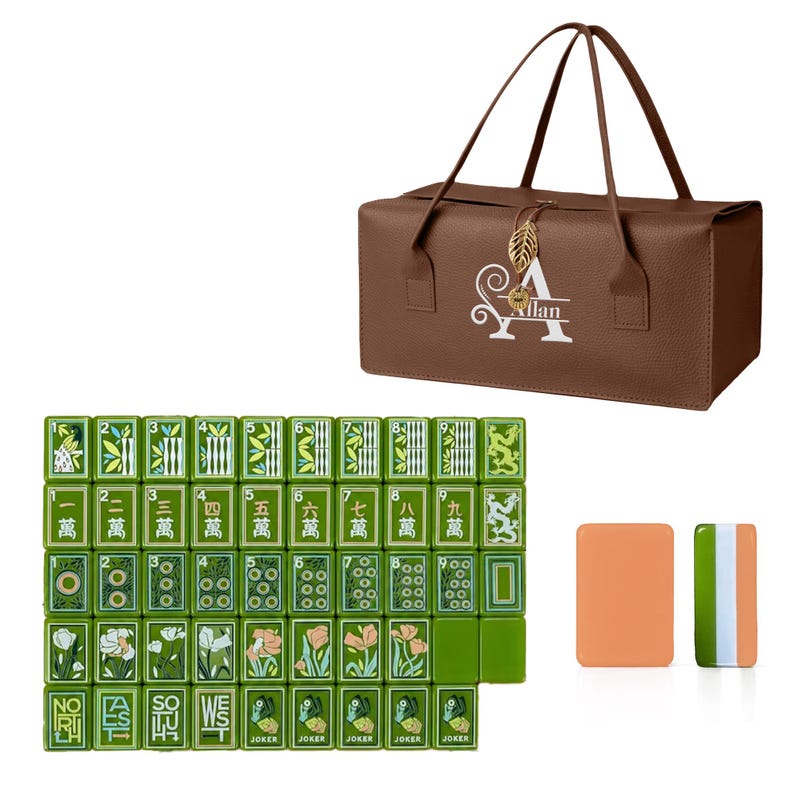May include: A brown rectangular carrying bag with a gold leaf charm and the name Allan printed in white, accompanied by a set of green mahjong tiles featuring floral, dragon, and numerical designs, plus two solid rectangular game pieces.