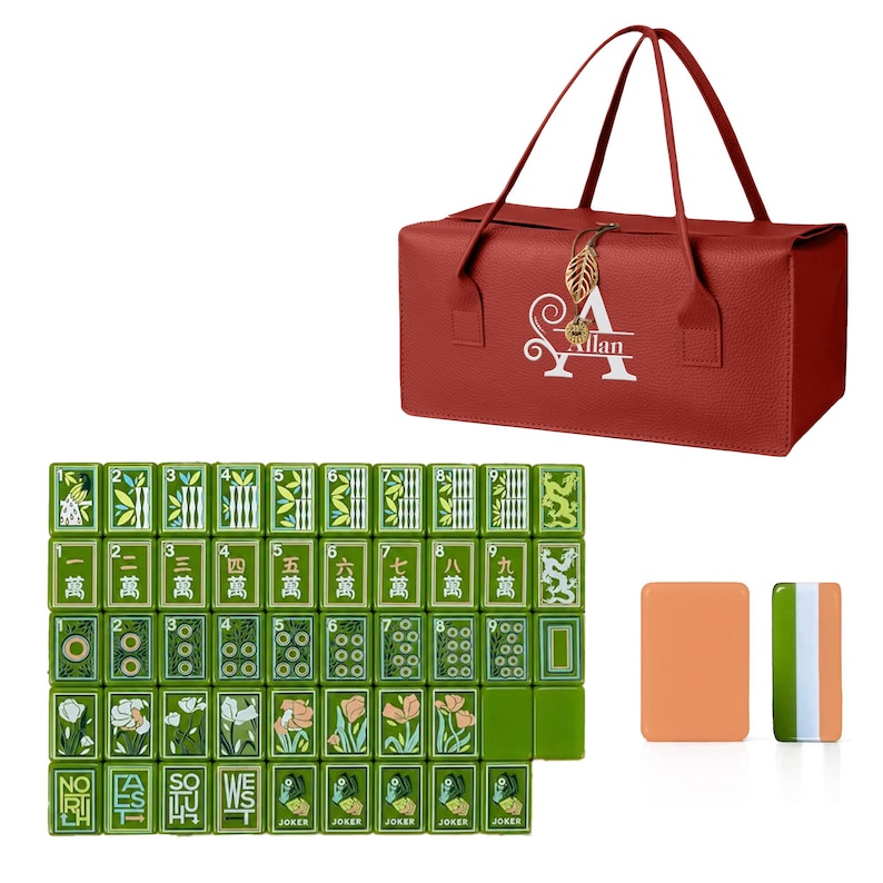 May include: A red rectangular carrying case with two handles and a gold leaf charm, featuring the white letter A and the name Allan. Below are green mahjong tiles with floral, dragon, and numerical designs, plus two plain rectangular tiles.