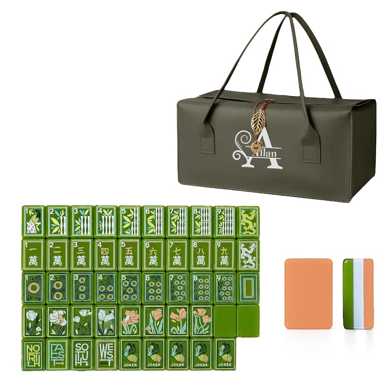 May include: An olive green rectangular carrying case with a gold leaf charm and the white text "A Allan" printed on the front, accompanied by a set of green mahjong tiles featuring floral, dragon, and directional designs, plus two blank tiles.