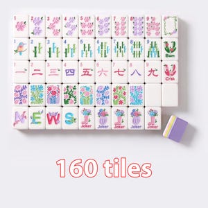 May include: A set of 160 white mahjong tiles featuring colorful floral, bamboo, bird, and Chinese character designs. The tiles include letters spelling NEWS, Joker tiles with flower vases, and specific suit markings with numbers 1 through 9.