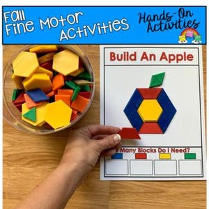 May include: A clear bowl filled with colorful geometric shapes next to a white card with a geometric apple design. The card reads "Build An Apple" and "Many Blocks Do I Need?" with a hand holding a shape. The text "Fall Fine Motor Activities Hands-On Activities" is at the top.