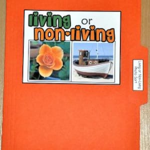 May include: An orange file folder with a white-bordered image of a rose and a boat, labeled "living or non-living." The file folder also has a small label that says "Living or Non-Living Photo Sort."