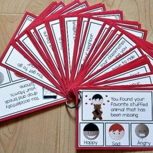 May include: A collection of red-bordered cards fanned out on a wooden surface. Each card has white text and illustrations. The cards have text such as "You Found your favorite stuffed animal that has been missing" and "Your classmates are missing you."
