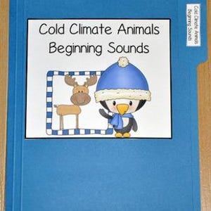 May include: A blue file folder with a white label featuring the text "Cold Climate Animals Beginning Sounds." The label includes illustrations of a cartoon moose and a penguin wearing a blue hat. The folder has a tab labeled "Cold Climate Animals Beginning Sounds."