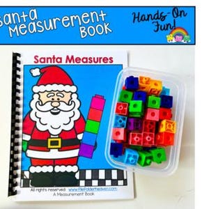 May include: A spiral-bound "Santa Measurement Book" with a cartoon Santa Claus illustration. A container of colorful cubes and a stack of multi-colored blocks are next to the book. The text "Hands-On Fun!" is above the book.