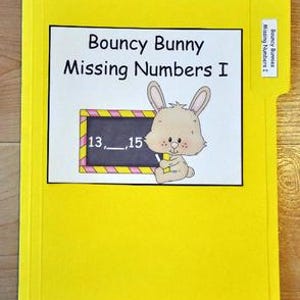 May include: A yellow file folder with a white label featuring the text "Bouncy Bunny Missing Numbers I." The label includes a cartoon bunny and a math problem with missing numbers. The file tab reads "Bouncy Bunny Missing Numbers I."