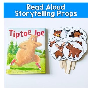 May include: A children's book titled "Tiptoe Joe" with a bear illustration, next to a set of storytelling props. The props are circular with animal illustrations and speech bubbles. The text "Read Aloud Storytelling Props" is at the top.