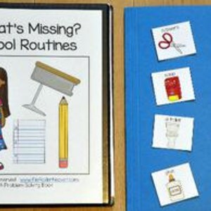 May include: A black binder with the text "What's Missing? School Routines" and a cartoon illustration. Next to it, a blue folder with several small cards featuring school-related images like scissors, a pencil, and a crayon.