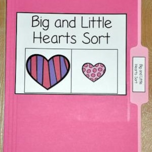 May include: A pink file folder with a white label that reads "Big and Little Hearts Sort." The label shows a large heart with purple and pink stripes and a small heart with pink polka dots. The tab on the folder also reads "Big and Little Hearts Sort."